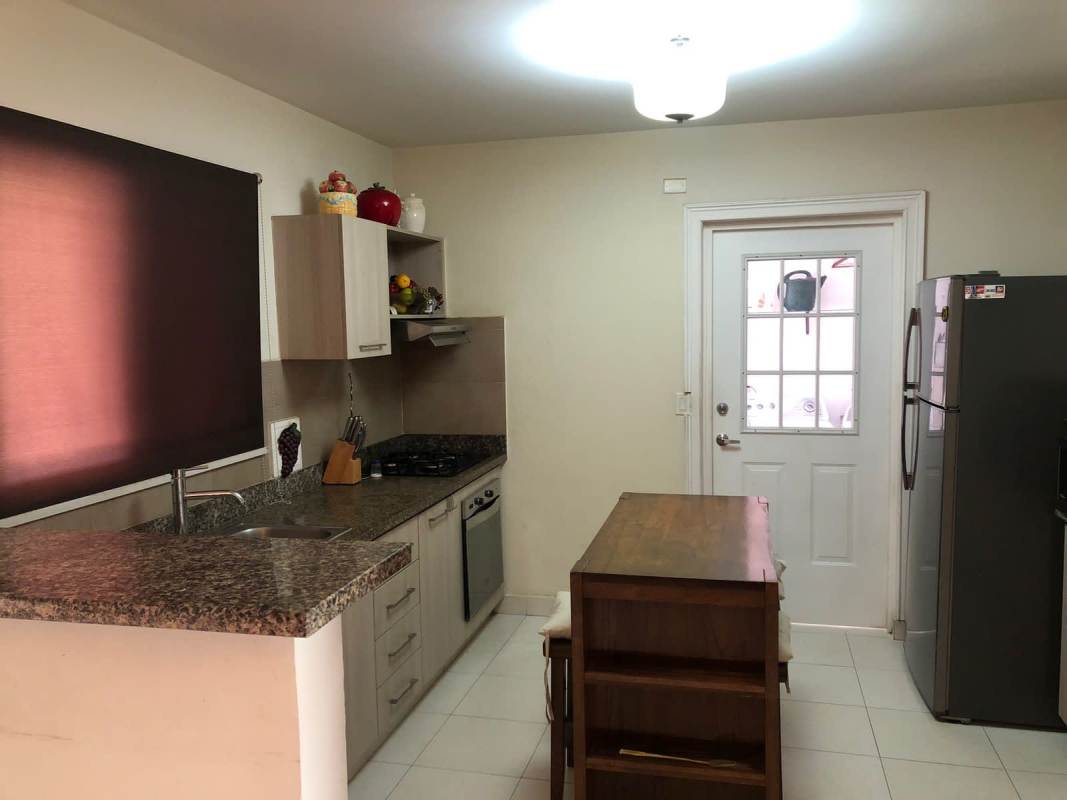 Contemporary kitchen with granite countertops in Costa Sur house Quintas de Versalles Panama