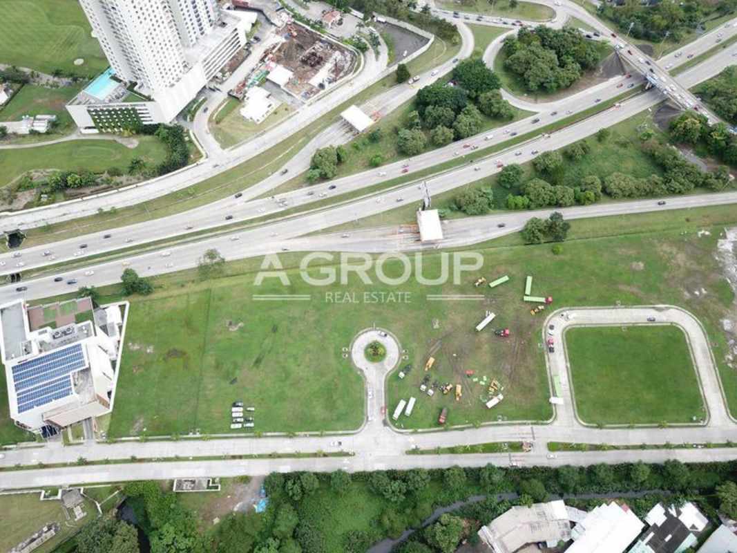 Aerial urban scene highlighting highways, open land parcel, buildings in Santa Maria Business District Panama