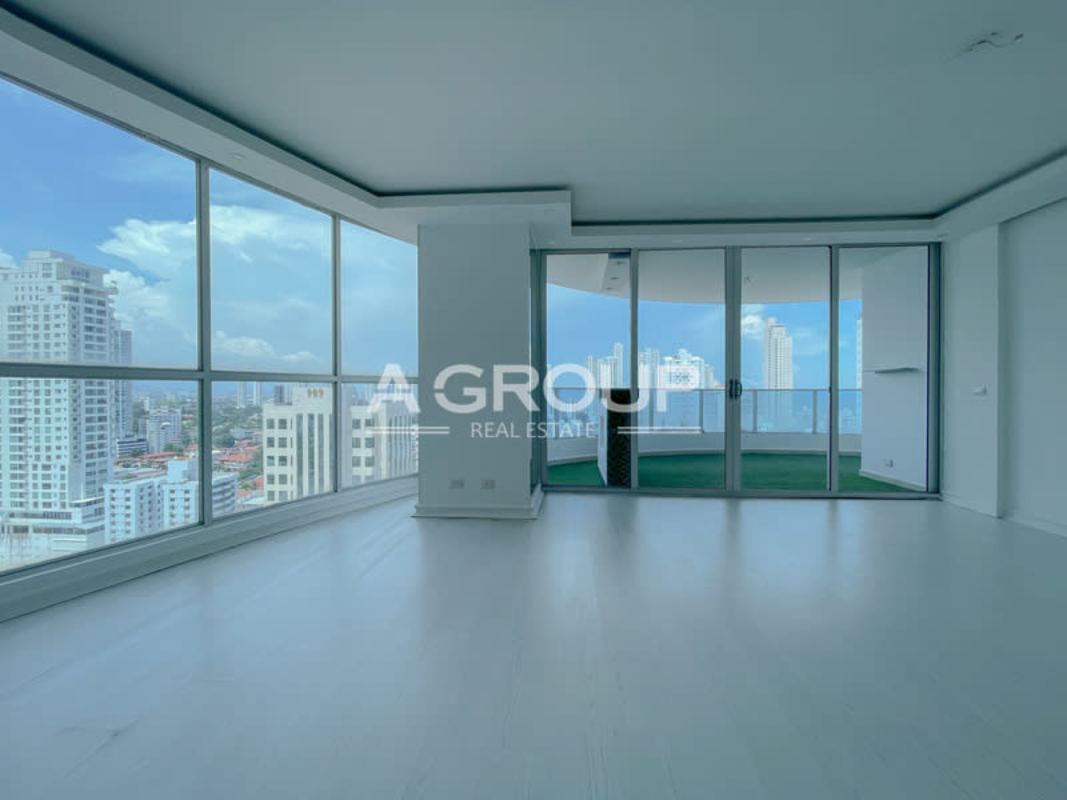 Spacious modern living room with floor-to-ceiling windows and balcony at Joy Tower in San Francisco Panama