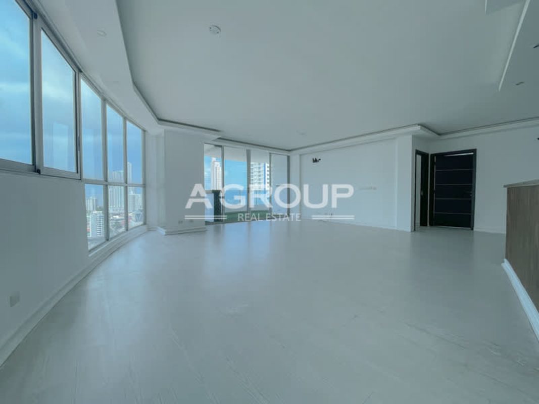 Spacious apartment living room with panoramic windows and city view balcony Joy Tower Panama