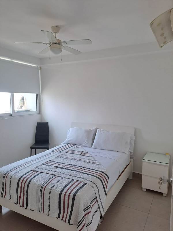 Living room with white sofa, large windows to Panama Bay, PH Belle View