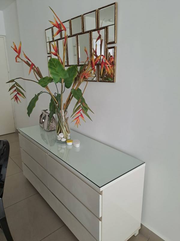 Bright modern living space with city views, white furniture, glass coffee table at PH Belle View Panama City