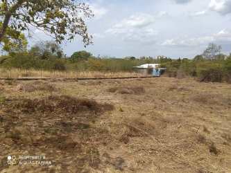 Partially fenced open beach land with small shed at Rio Mar community Panama