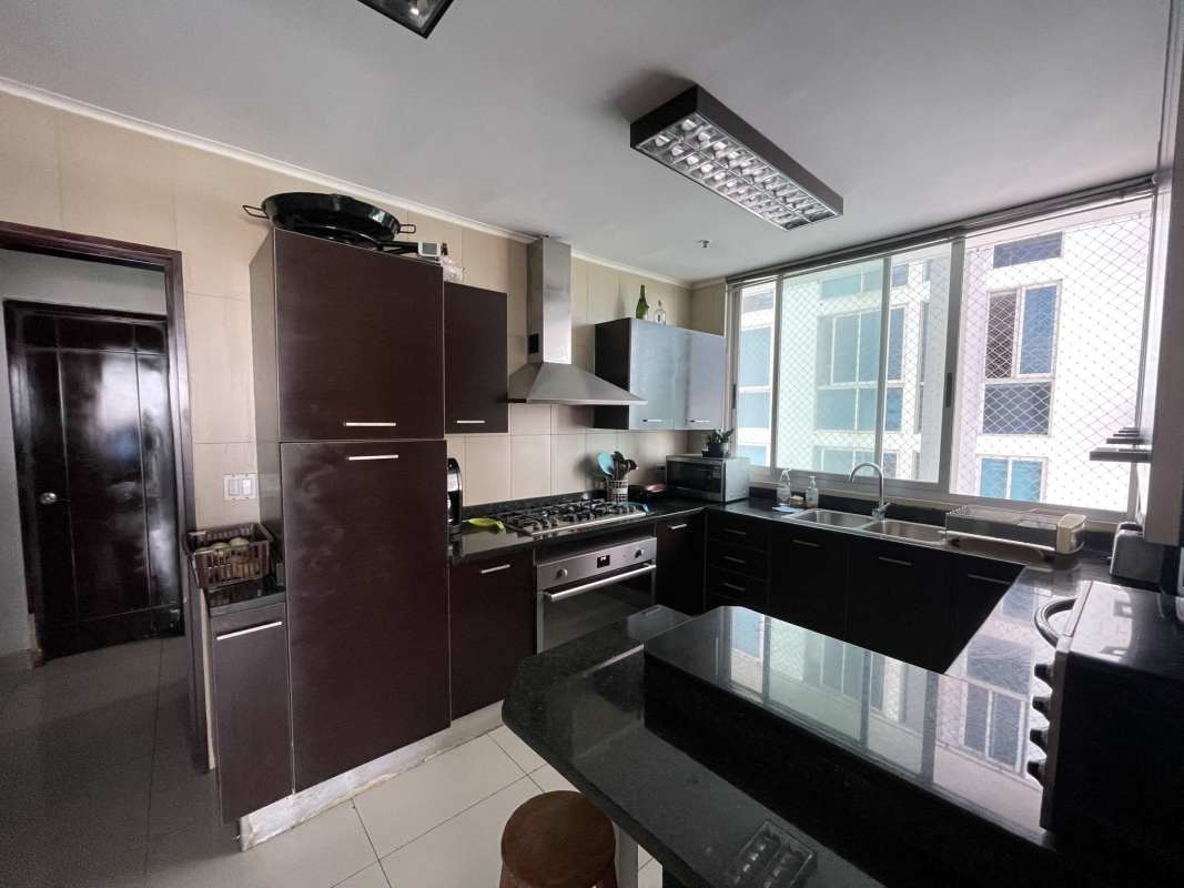 Sleek kitchen with granite countertops, stainless appliances at PH Latitude Costa del Este Panama