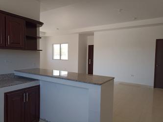 Contemporary kitchen with granite countertop, wood cabinets, breakfast bar in Rio Grande Penonomé