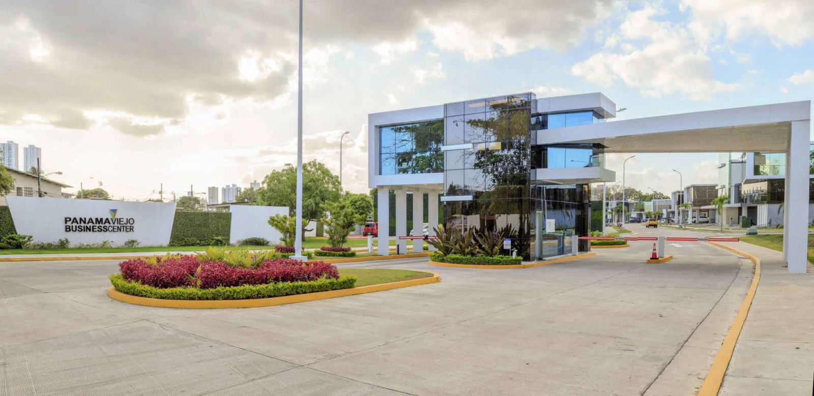 Modern industrial warehouse facade with concrete yard and roller entry in Panama Viejo Business Center