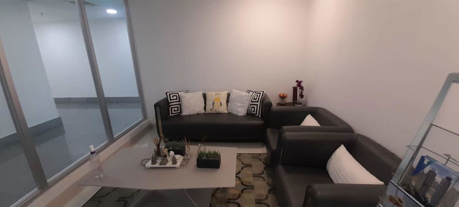 Modern kitchenette with cabinets, sink, and small appliances in Costa del Este office