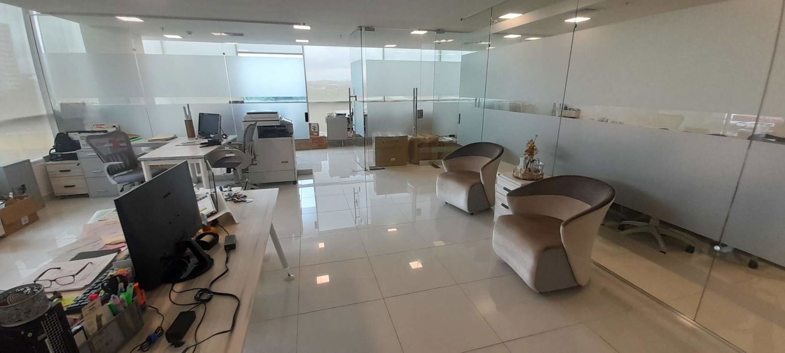 Conference room with glass walls, large table, wall screen at Costa del Este office rental