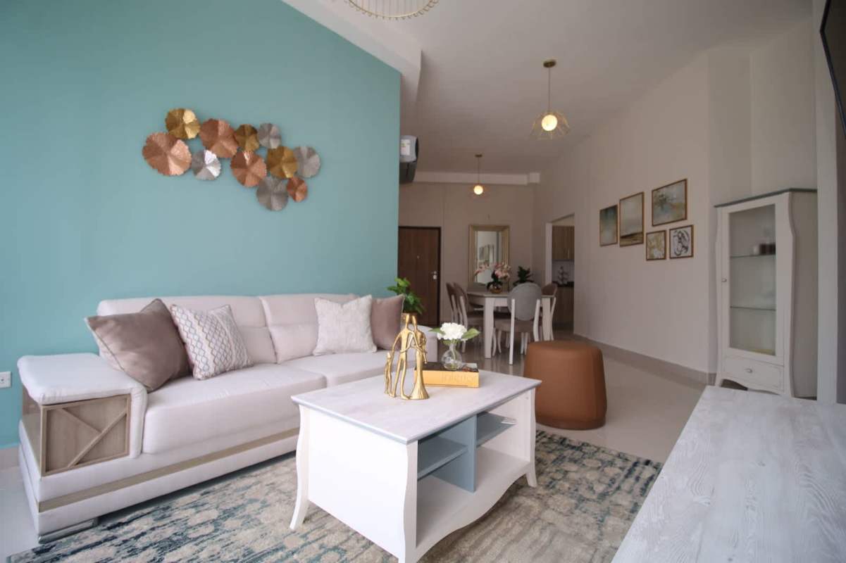 Modern living space with teal accent wall and open dining area PH Bella Veduta Panama