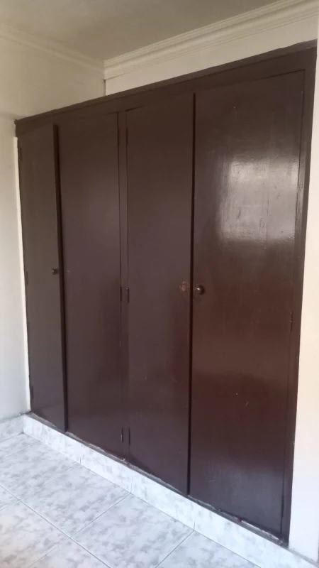 Compact kitchen with tile countertops and white cabinetry in PH Santa Elena Panama