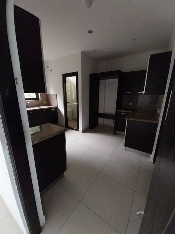 Kitchen with granite countertops dark wood cabinets tiled floor PH Embassy Village