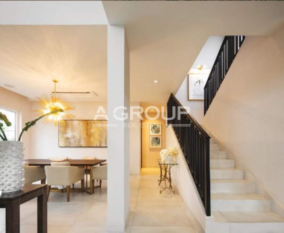 Dining area with chandelier and staircase luxury duplex Santa María Golf Panama