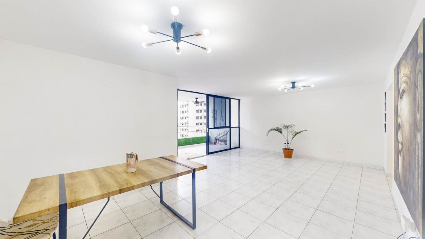 Large bright living-dining area with balcony access and skyline views in PH Perla del Pacífico