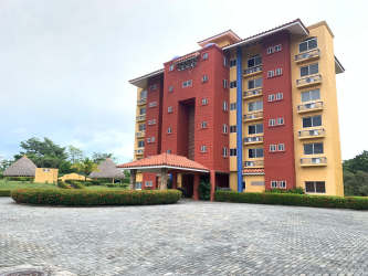 Bright open living room and dining with access to ocean-view terrace at Punta Barco Resort Panama