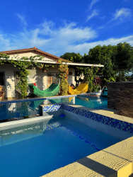 Covered gazebo with outdoor dining area surrounded by lush garden in Las Uvas Panama