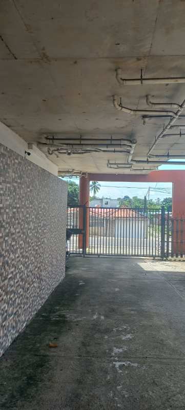 Covered concrete driveway entrance with security gate PH Vitto Pedregal bank-owned apartment complex Panama City