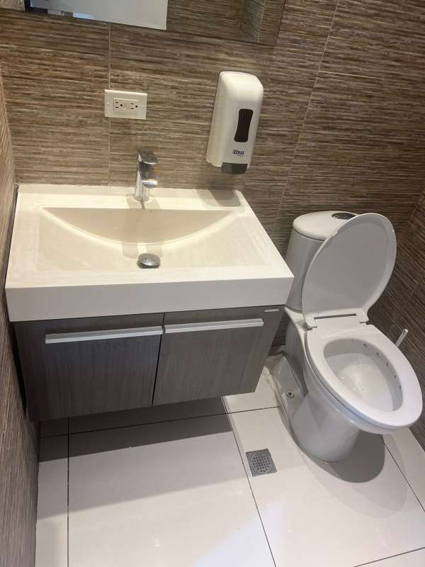 Spacious open plan office with large windows, wood accents, glass tables Obarrio Panama