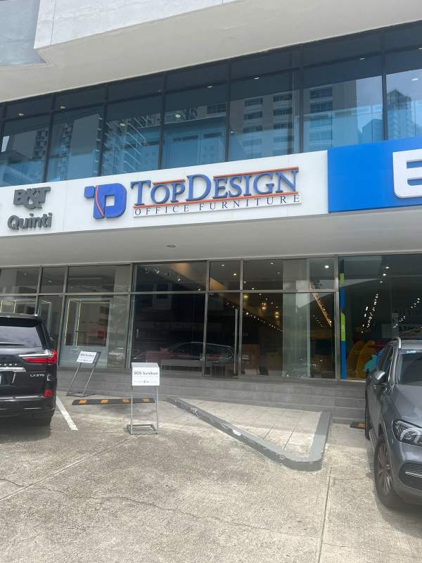 Modern reception lobby area with pendant lights, wood panel walls, and glass tables Obarrio Panama