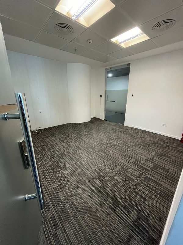 Interior private workspace glass walls drop ceiling carpet flooring in Punta Pacifica Oceania Plaza Panama