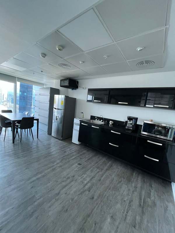 Furnished open workspace with modular cubicles and carpet flooring inside Oceania Business Tower Panama