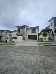 Spacious modern living room with natural light, tile flooring and ceiling fan Nativa Panama Pacifico