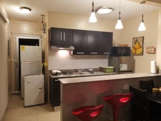 Modern kitchen with granite counters and cabinets in Las Guias Beach House Panama