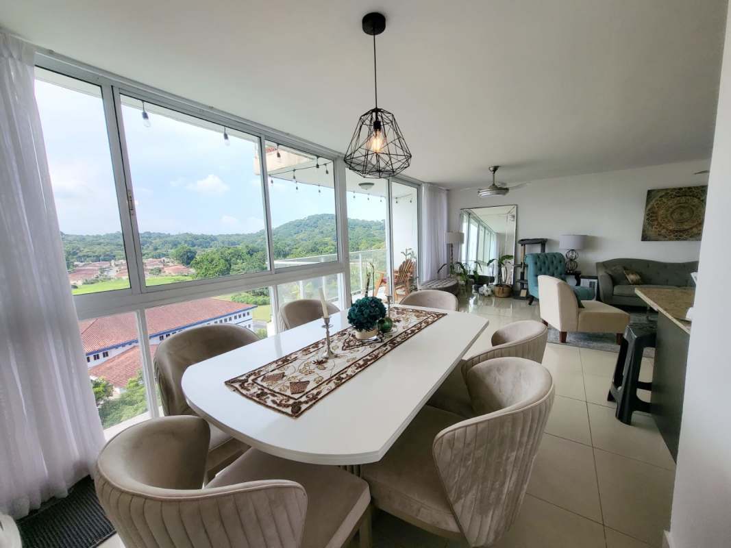 Open concept bright dining and living room with floor-to-ceiling windows scenic views at PH Pine Hill Albrook Panama