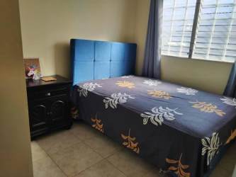 Small bedroom with blue headboard tiled floors for sale in La Chorrera Panama