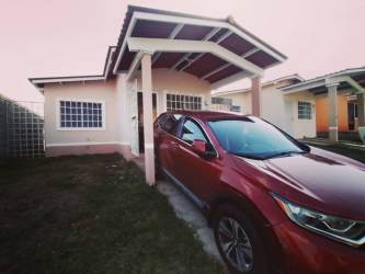 Single-story house peach facade covered carport La Chorrera Panama for sale