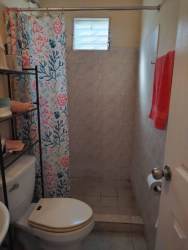 Bathroom with walk-in shower and curtain compact design house for sale La Chorrera Panama