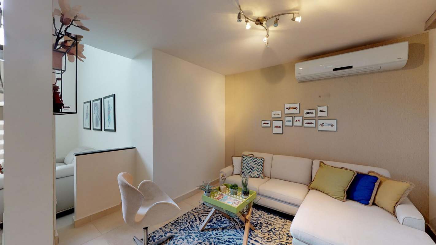 Bright family living space with sectional couch and AC in Villasur Residences Panama