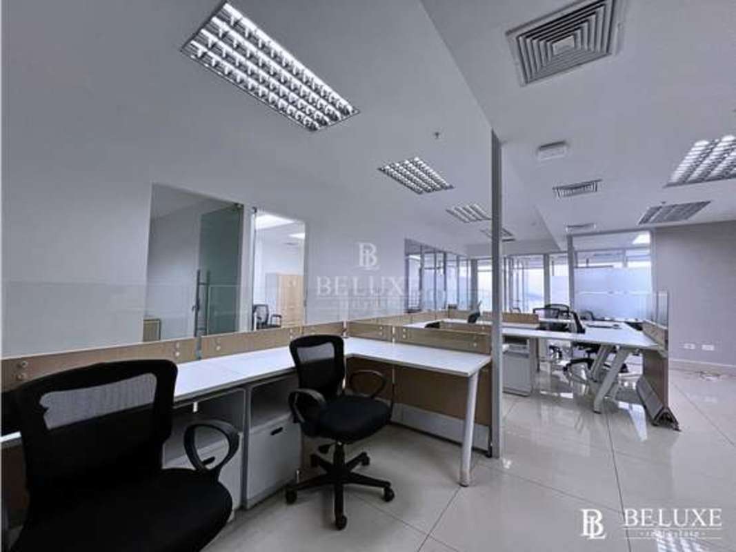Bright private office with glass partitions and skyline views at PH BICSA Panama