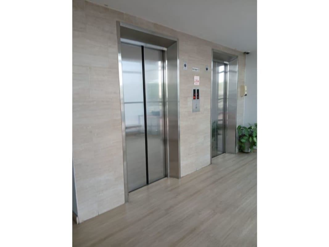 Elegant elevator lobby with stainless steel elevators and marble walls PH El Mare 4000