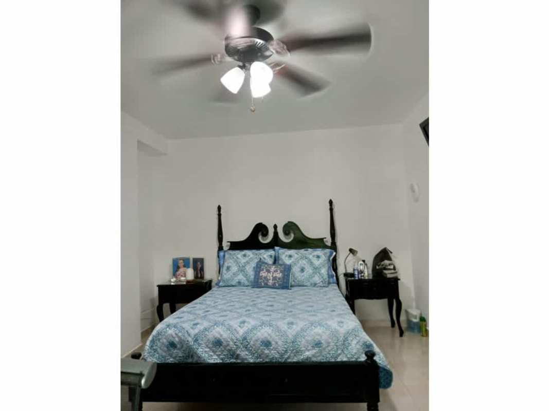 Traditional master bedroom with ceiling fan, blue bedding, and closet at PH El Mare 4000 Panama