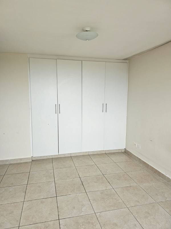 Bedroom with built-in white closet at Condado Country Club Panama City
