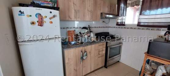 Renovated kitchen with brown cabinets granite-style countertop window in Los Olivos Panama