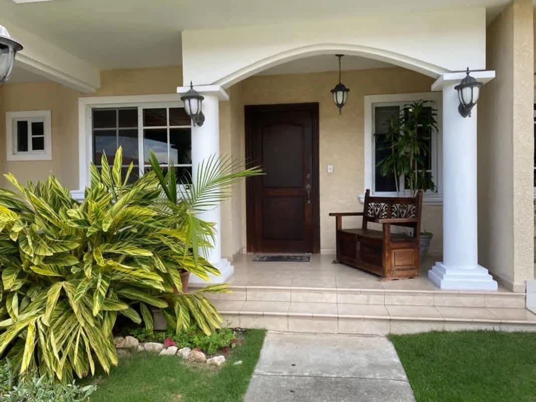 Mediterranean home front porch with columns and manicured lawn Costa del Este Panama