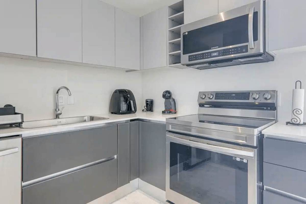 Guest bedroom floor-to-ceiling windows balcony ocean view JW Marriott condo