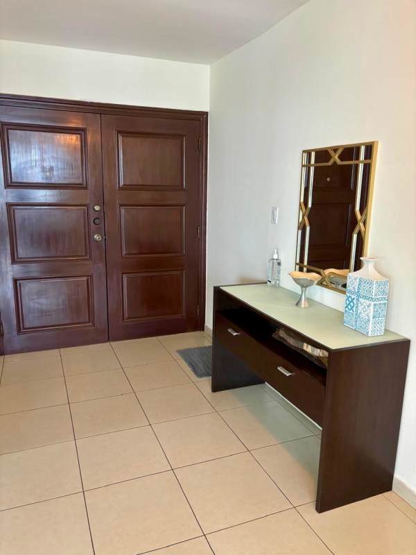 Furnished master bedroom with panoramic windows, skyline view, king bed, ensuite bath in PH Sol Marina Panama