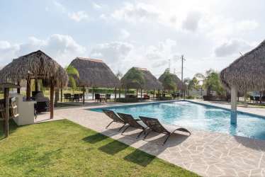 Outdoor pool with palapas and loungers in Punta Paraíso Village Nueva Gorgona Panama