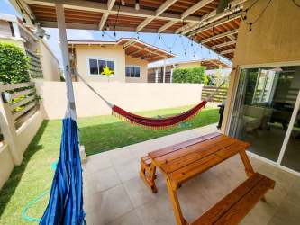 Open living dining area with ceiling fan and large window in Nueva Gorgona beach house