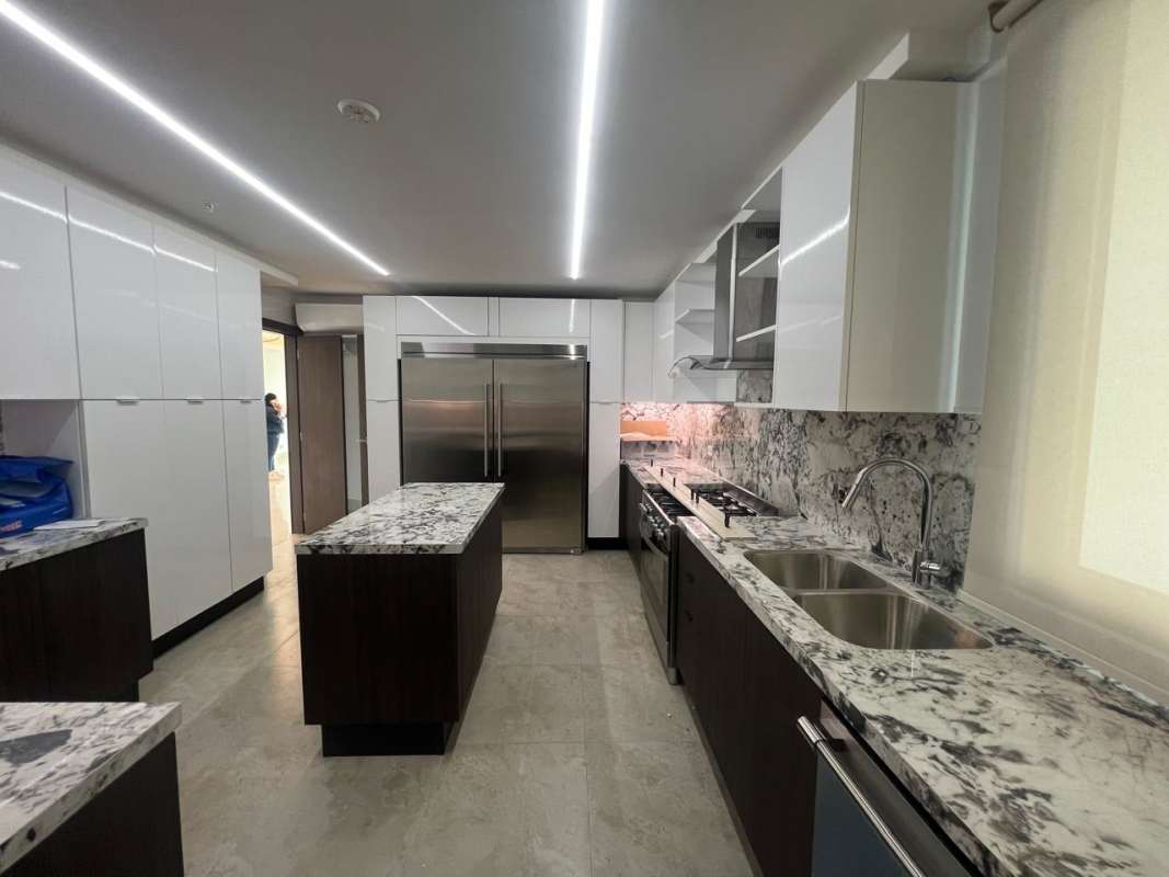 Modern marble kitchen with island, stainless steel appliances in Santa Maria Tower One Panama