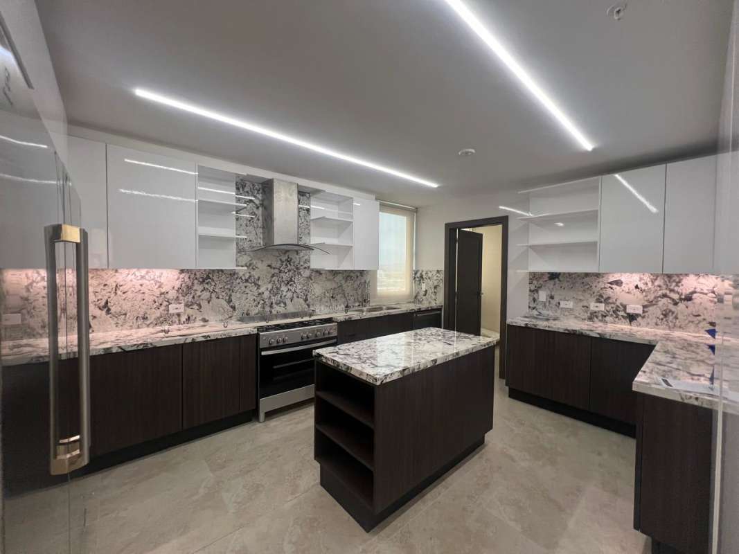 Spacious living room with marble floors and large panoramic windows at Santa Maria Tower One Panama