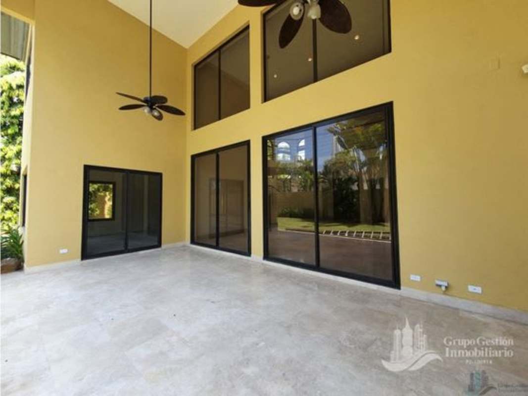 Large covered terrace opening to landscaped private garden in luxury home Residencial Antigua Panama