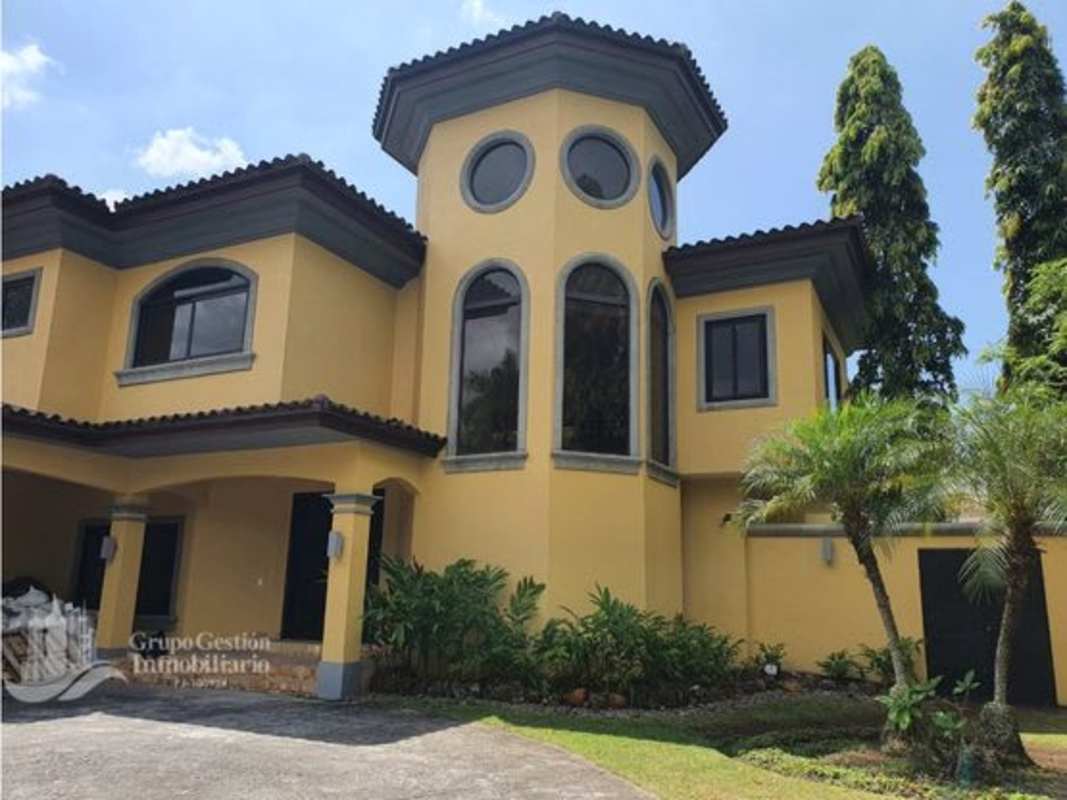 Exterior of 2-story Mediterranean villa in Residencial Antigua Costa del Este with lush landscaping