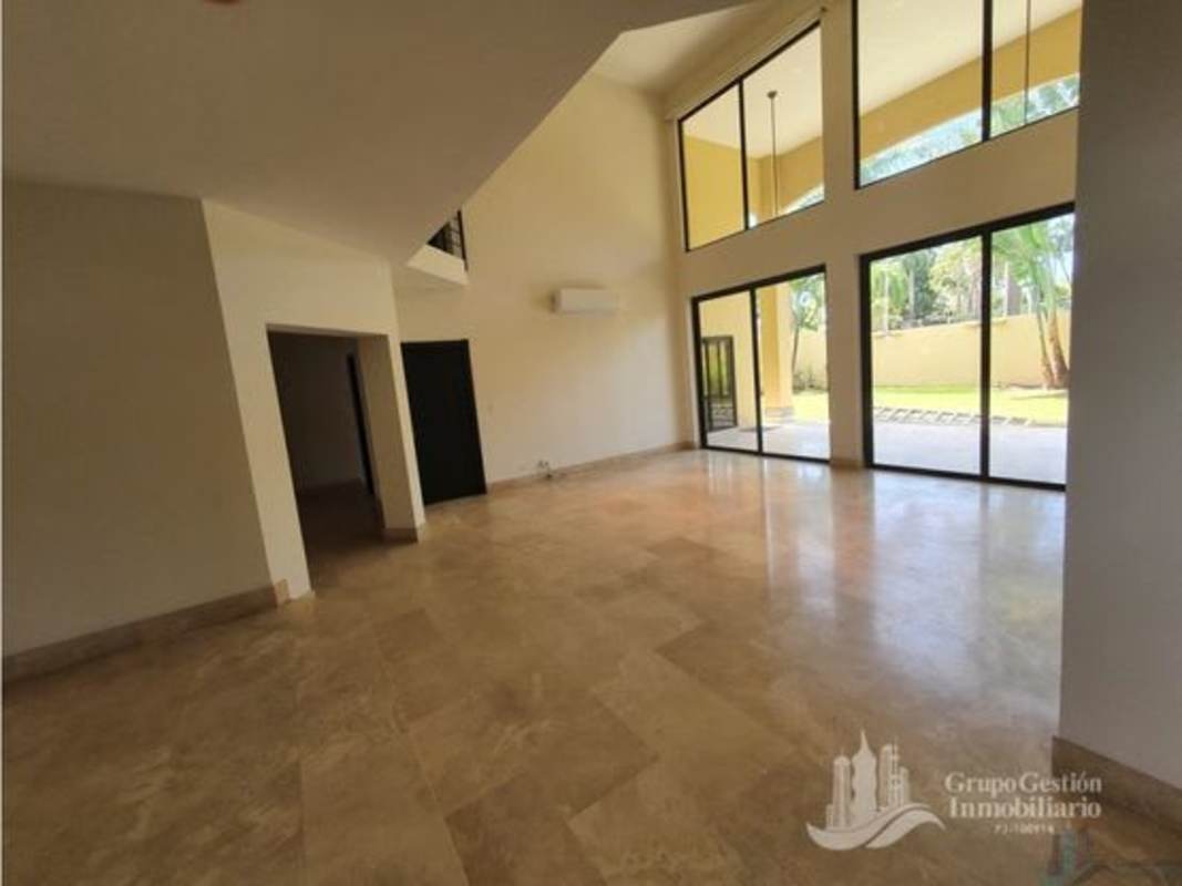 Spacious double-height ceiling living room with marble floors in luxury house Costa del Este Panama