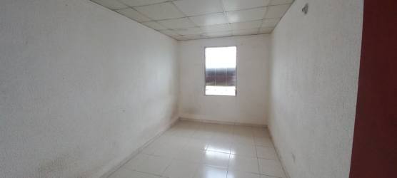 Basic bathroom setup with pedestal sink, mirror and tiled floor in foreclosure house