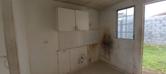 Basic unfurnished kitchen with wall cabinets and window in Vacamonte house