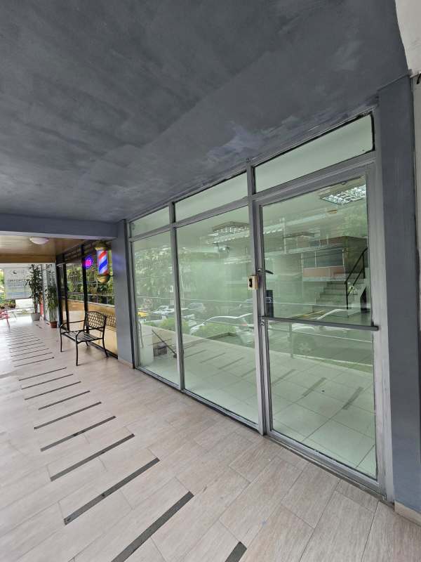 Glass storefront commercial property on Via Argentina with tiled walkway in Panama City