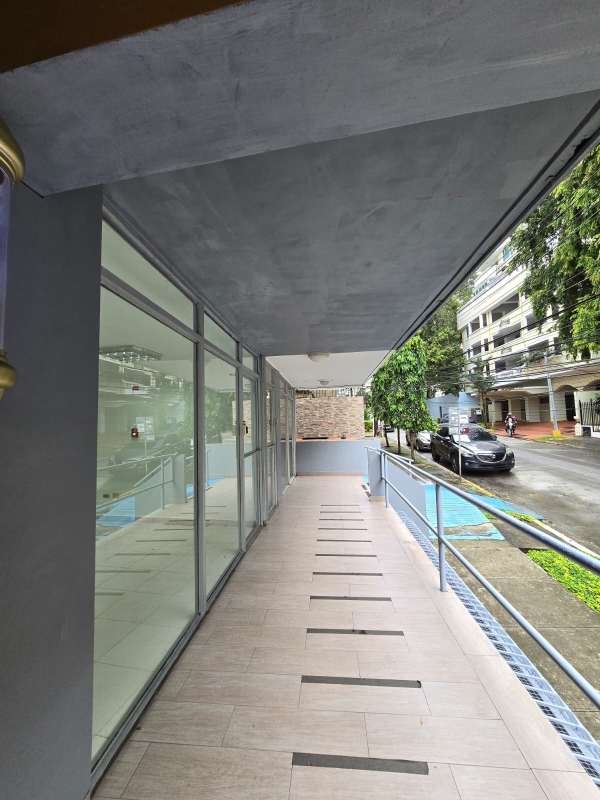 Commercial building with wheelchair accessible ramp and glass windows Via Argentina